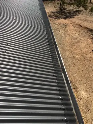 Black mesh gutter guard on corrugated metal roof