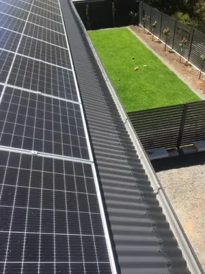 Charcoal corrugated gutter guard with roof vent