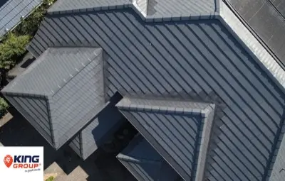 Gutter guard on corrugated roof beside solar panels
