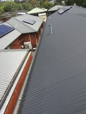 Long charcoal corrugated roof with clean gutter line