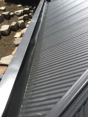 Colour-matched terracotta mesh on tiled roof gutter