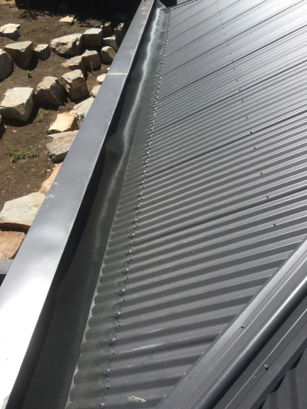 Colour-matched gutter guard on tile roof