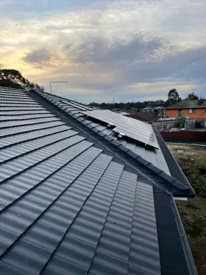 Multi-gabled tile roof during gutter guard installation